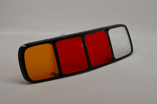 A rear left side red tail light lens for Porsche 928s.