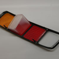 A rear left side red tail light lens for Porsche 928s. 