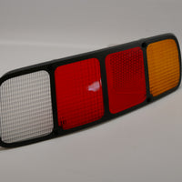 A rear right side tail light lens for Porsche 928s.